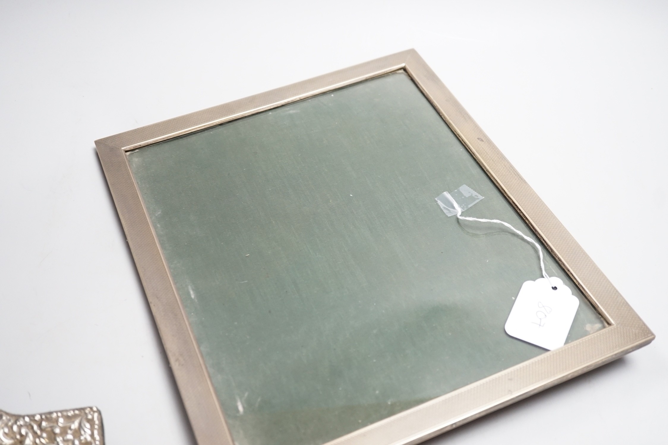 A large 1920's engine turned silver mounted rectangular photograph frame, Birmingham, 1928, 33.2cm and two other silver mounted photograph frames including circular.